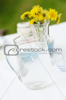 Jug of water and glasses on a table.