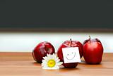 Delicious red apples on desk with blackboard 