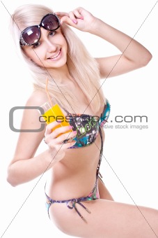 beautiful women in swimsuit with a glass of juice