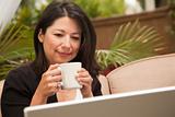Hispanic Woman with Coffee and Laptop On Her Patio.