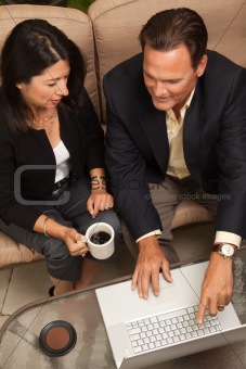 Man and Woman Using Laptop with Coffee