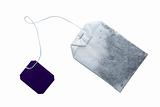 Tea bag with violet tag isolated on white. Clipping path included.