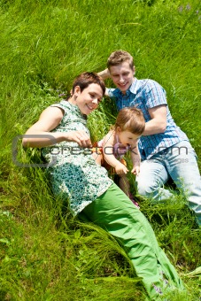 Family lying in grass