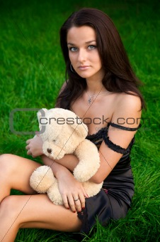 Young woman sitting on green grass