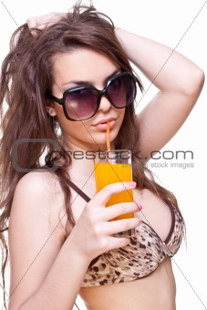 beautiful women in swimsuit with a glass of juice