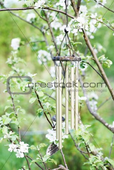 Windchime with floral background.