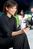 Beautiful Young Asian Woman Texting and Drinking Coffee