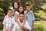 Happy Hispanic Family Portrait In the Park.