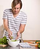 Attractive male making salad