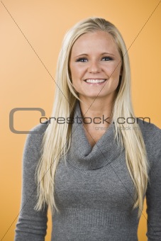 Smiling blond woman with sweater.