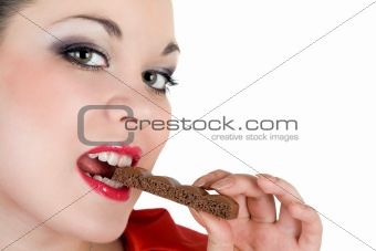 Portrait of the beautiful young woman eating chocolate