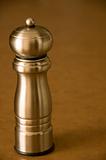 Pepper mill sitting on a bworn kitchen counter