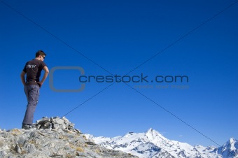 man looking over a mountain range,