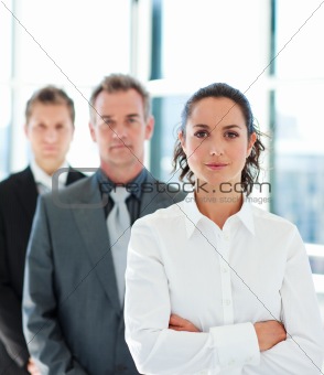Businesswoman with folded arms in a line