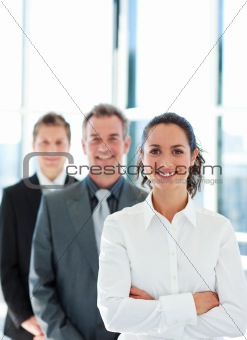 Smiling businesswoman with folded arms in a line