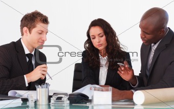 Three business people discussing in a meeting