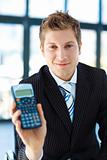 Young businessman holding a calculator