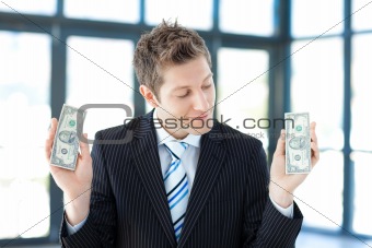 Smiling businessman holding money