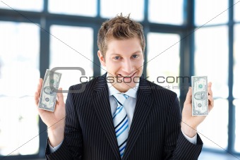 Young businessman holding money