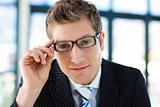 Businessman looking to the camera with glasses