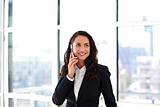 Smiling young businesswoman talking on phone