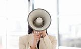 Portrait of a businesswoman shouting through megaphone