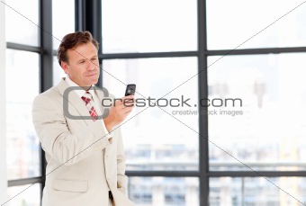 Senior businessman texting with copy-space