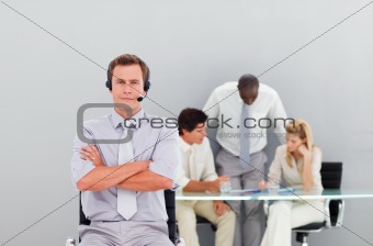 Businessman with a headset on with folded arms
