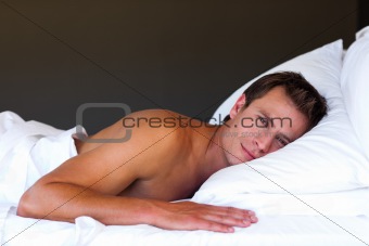 Handsome boy relaxing in bed