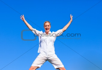 Happy woman jumping against blue sky