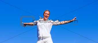 Happy woman jumping outdoors