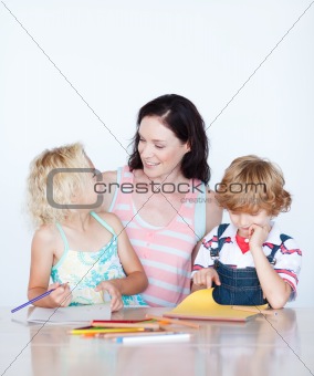 Mother and children drawing together