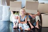 Parents and daughter playing at home with boxes