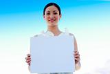 Businesswoman holding a blank board