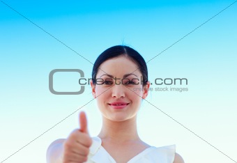 Portrait of a businesswoman outdoors with thumbs up