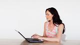 Attractive woman using her laptop with copy-space