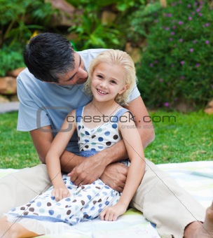 Father playing with his daughter in a garden