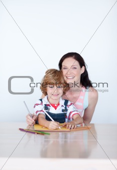 Mother and son writing and smiling to the camera
