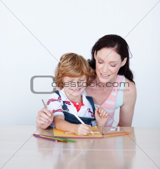 Mother and son writing together