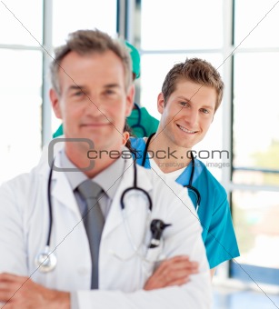 Smiling young doctor in focus in a line