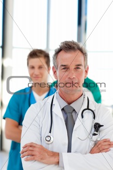 Friendly mature doctor leading his team