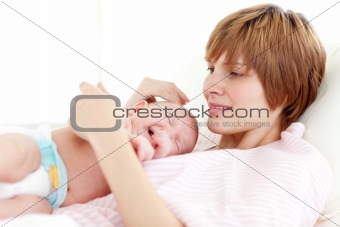 Mother attending to her newborn baby