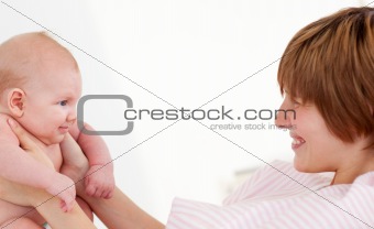 Woman playing with her newborn baby