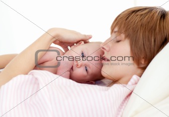 Mother sleeping with her newborn baby