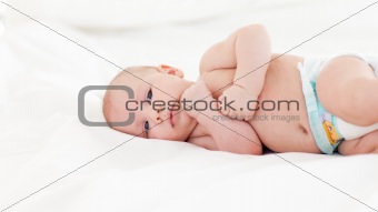 Beautiful baby lying in bed