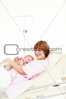 Mother embracing her newborn baby with copy-space