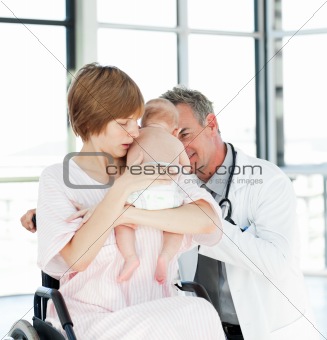 Mother with her newborn baby and doctor