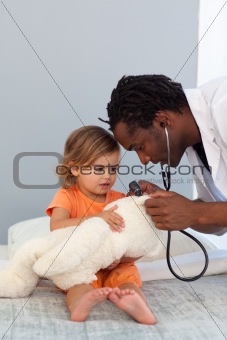 Pediatrician talking to a little girl 
