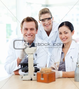 Young scientists working with a microscope