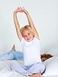Young child stretching after sleeping